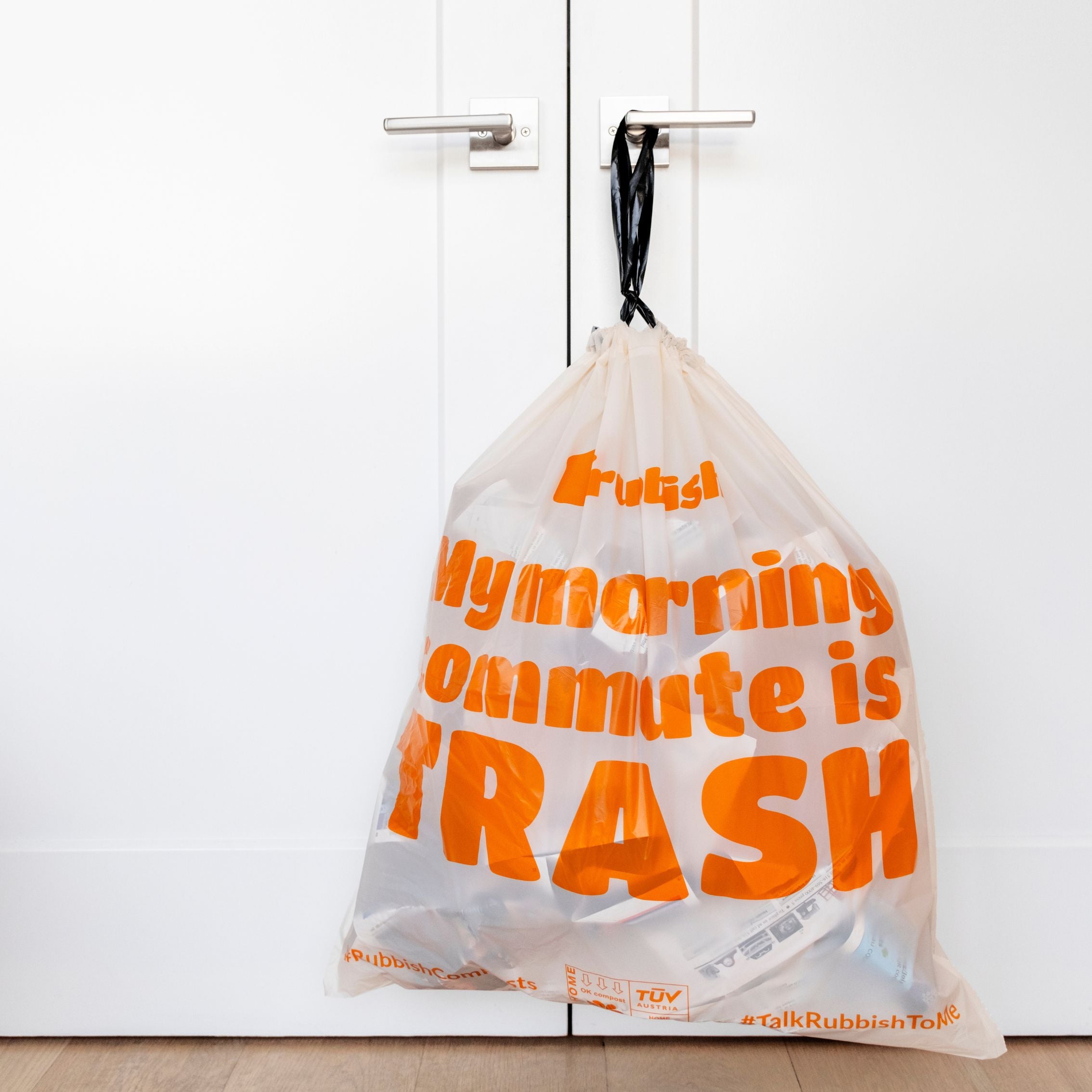 Rubbish Home trash bags - slogan hanging on door handle